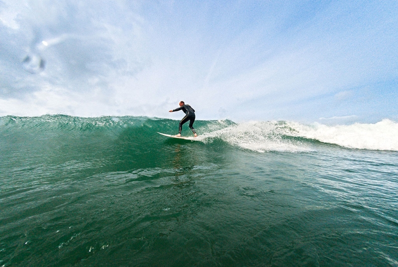 surfer riding wave Whitesands Bay
